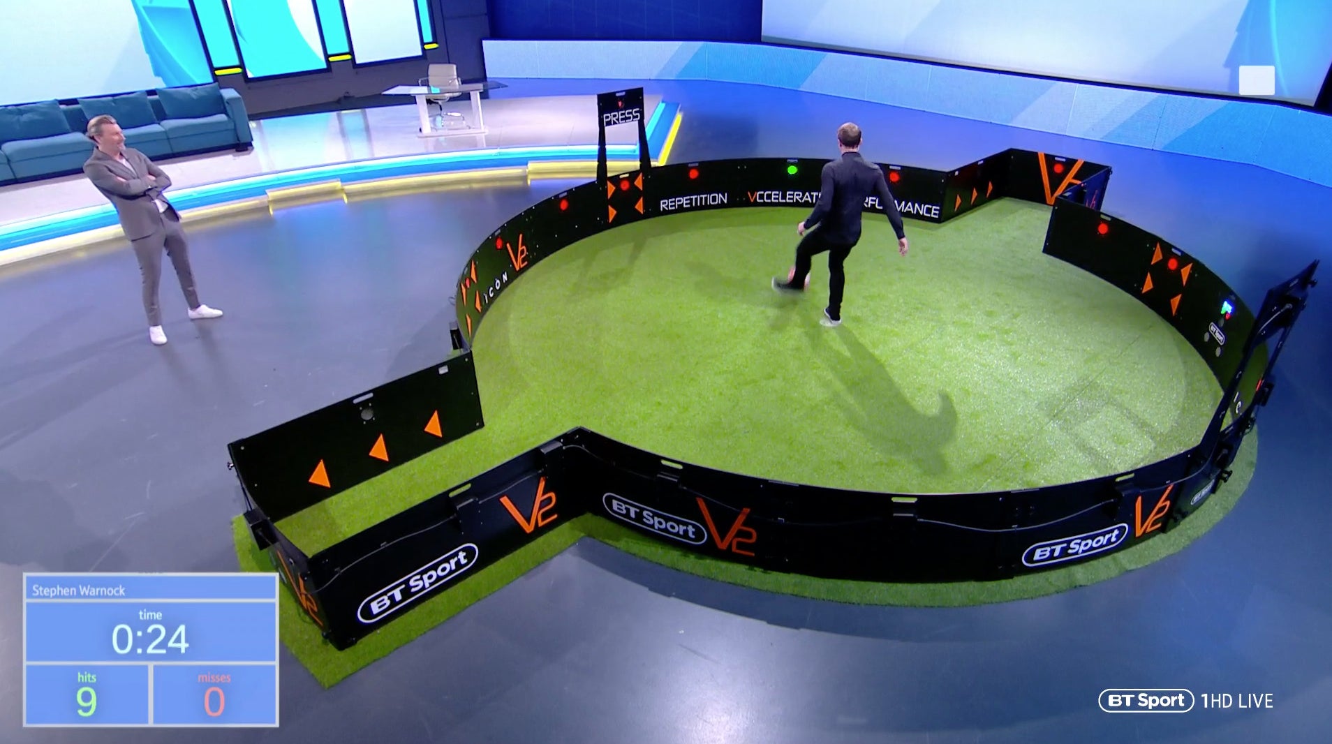 Man using acura icon v2 on bt sport tv with man spectating
