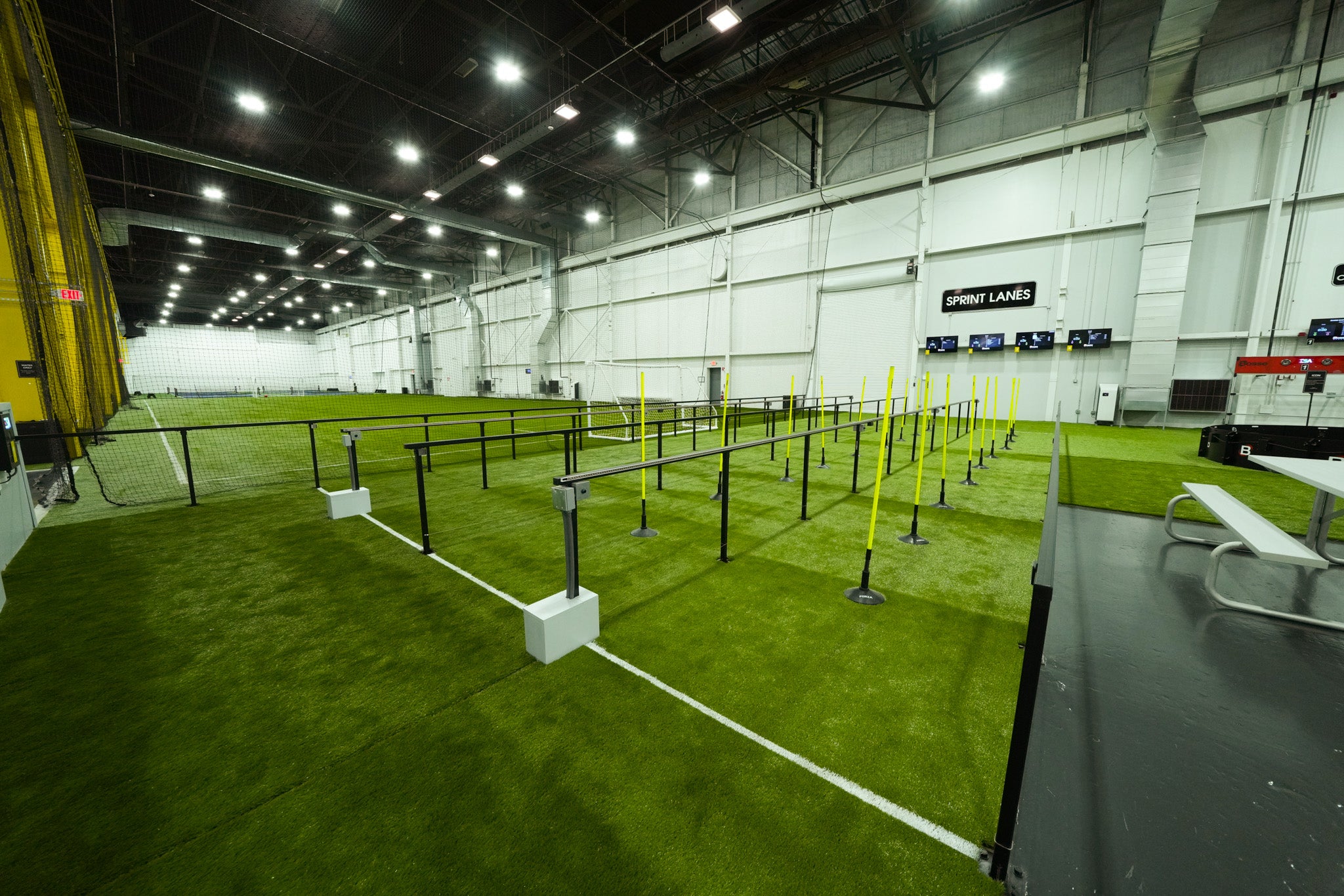 indoor facility with sprint lane and dribble lane on astro and yellow dribble lane obstacles for users to move the ball around
