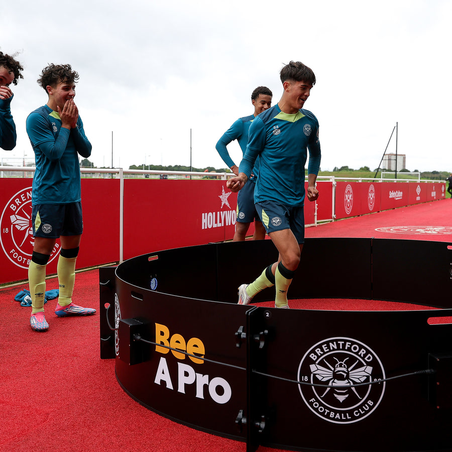 boy using icon fast feet with brentford fc branding on panels and other boys watching him laughing