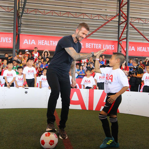 David beckham hi fiving child while using Acura Elite ICON Arena