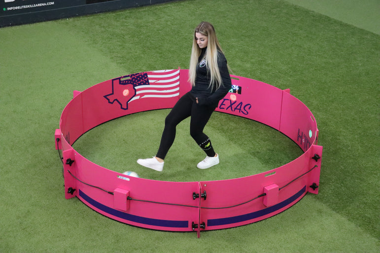 girl playing football in acura elite icon fast feet with pink texas branding