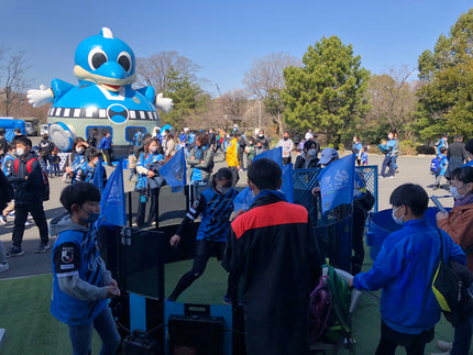 festival with kids playing football inside acura elite icon fast feet with inflatable blue mascot in background