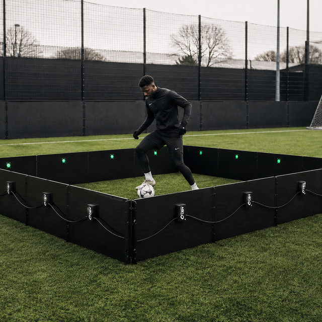 man playing football inside acura elite icon cube 16 panel outside on field