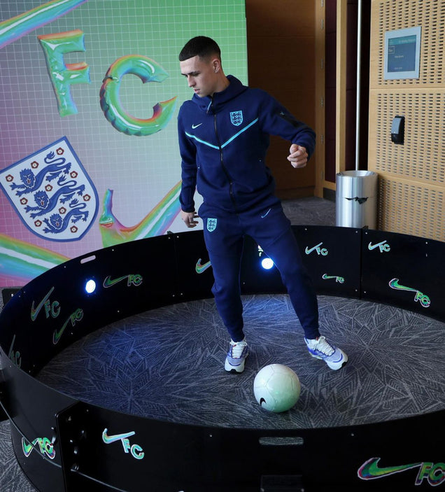 Phil Foden in nike tracksuit using acura elite icon fast feet with branding on outer panels.