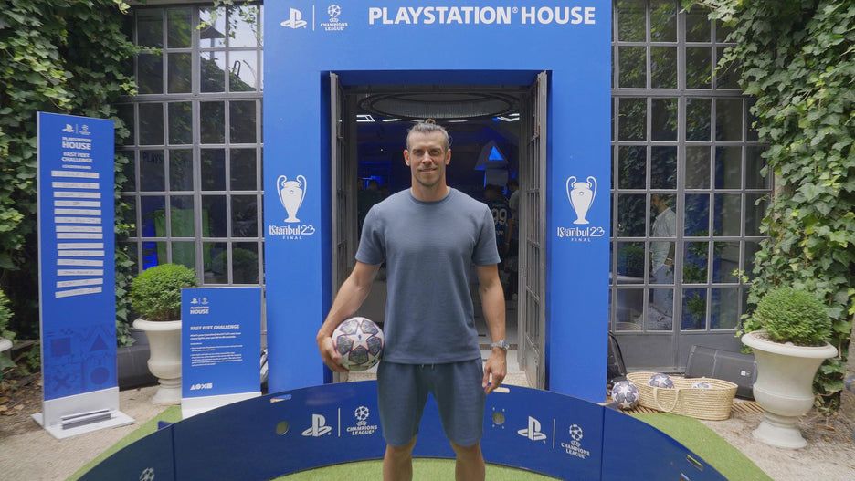 Gareth Bale standing with football in blue branded acura elite icon arena
