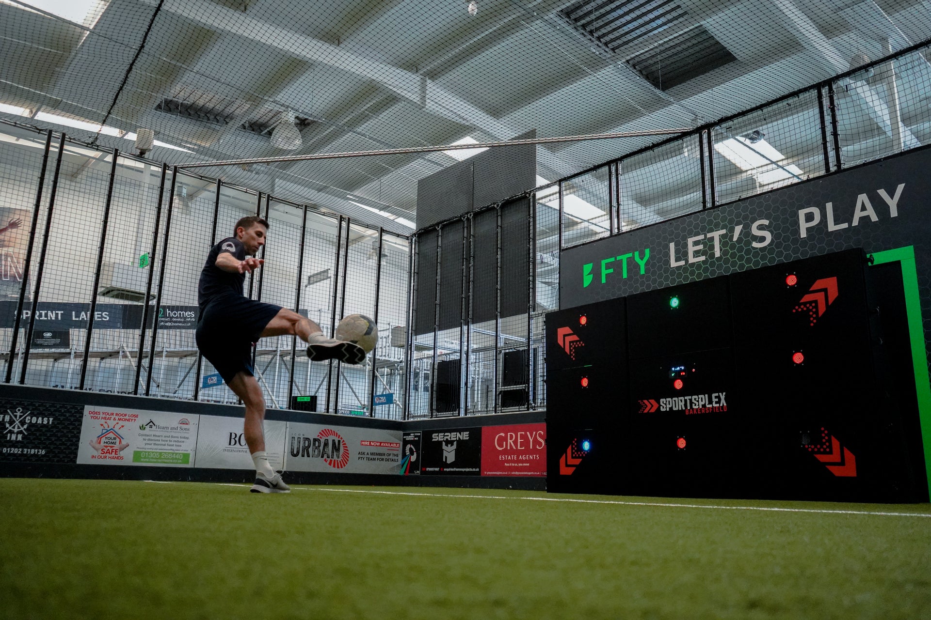 man kicking ball at precision wall 9 panel on grass