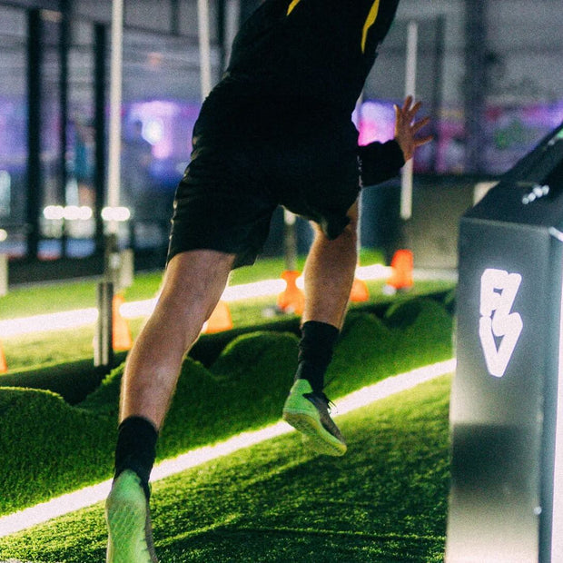 man sprinting inside using acura elite training lane (sprint)