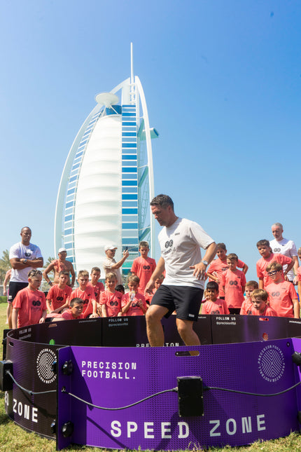 man using acura elite icon fast feet in dubai with spectators and burj al arab in background