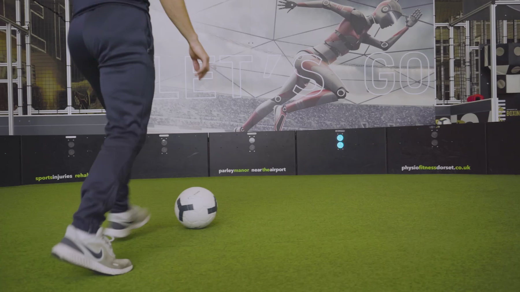 video of man demonstrating how pass finder 3 game mode works on acura elite esa products inside training facility with astro turf
