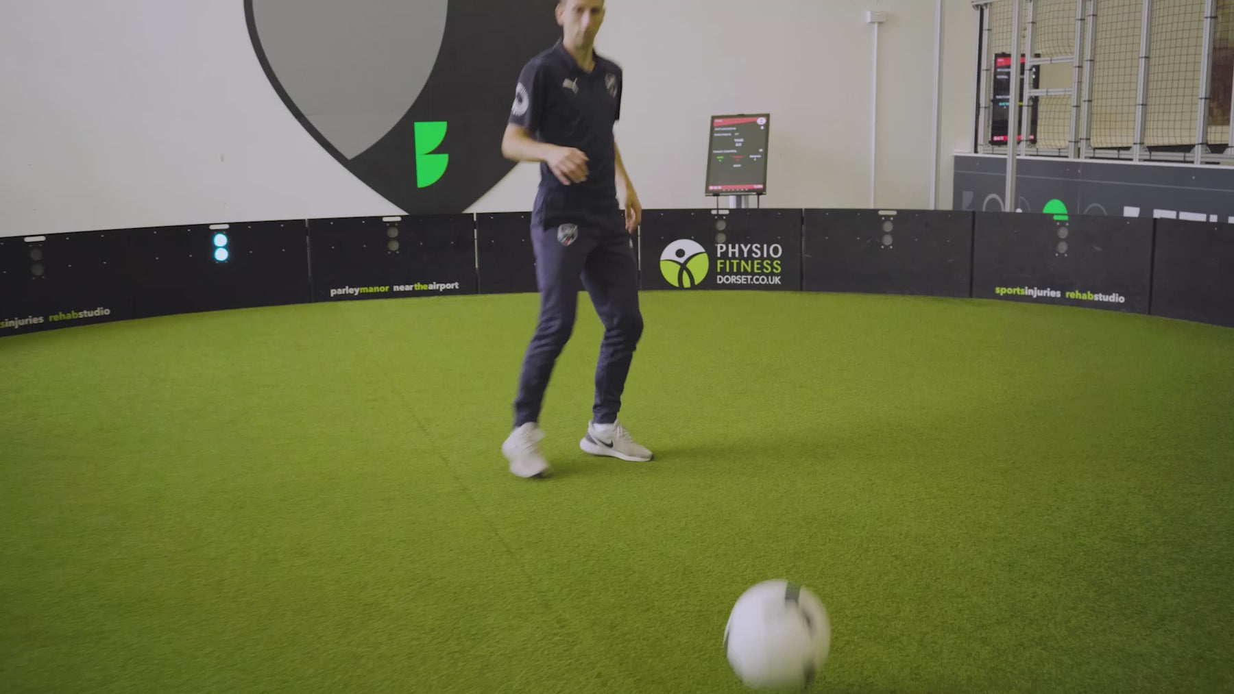 video of man demonstrating how pass finder n game mode works on acura elite esa products inside training facility with astro turf