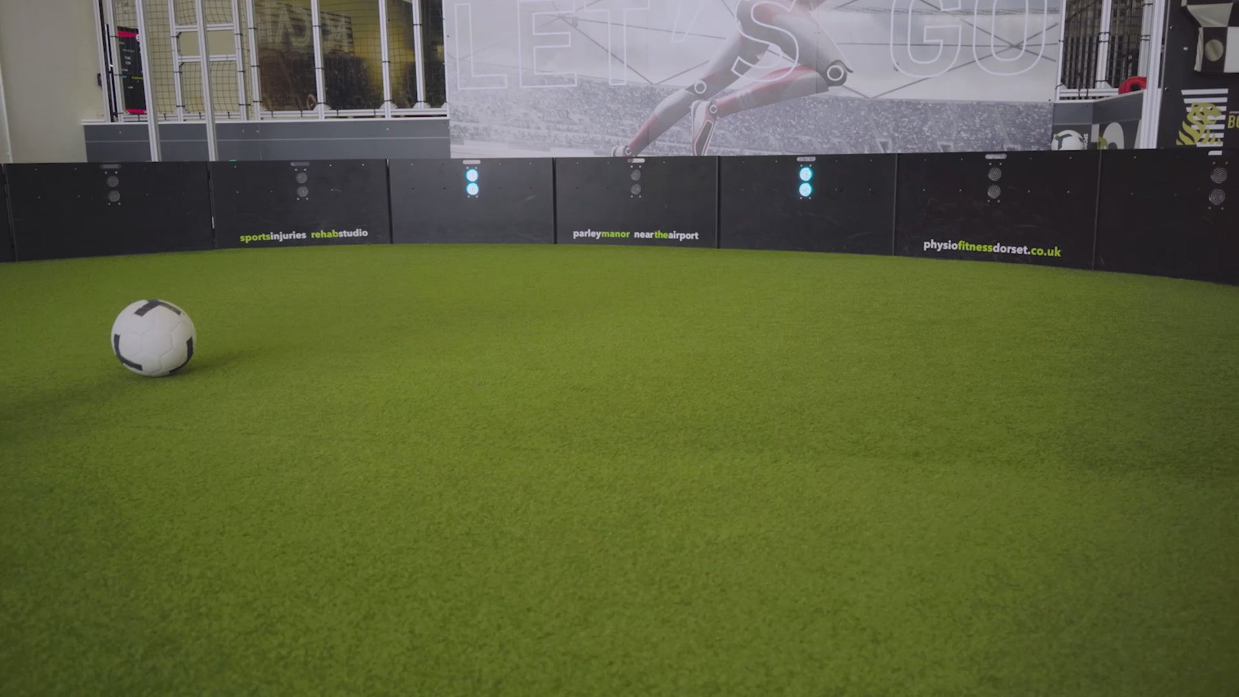 video of man demonstrating how pass finder 2 a products inside training facility with astro turf