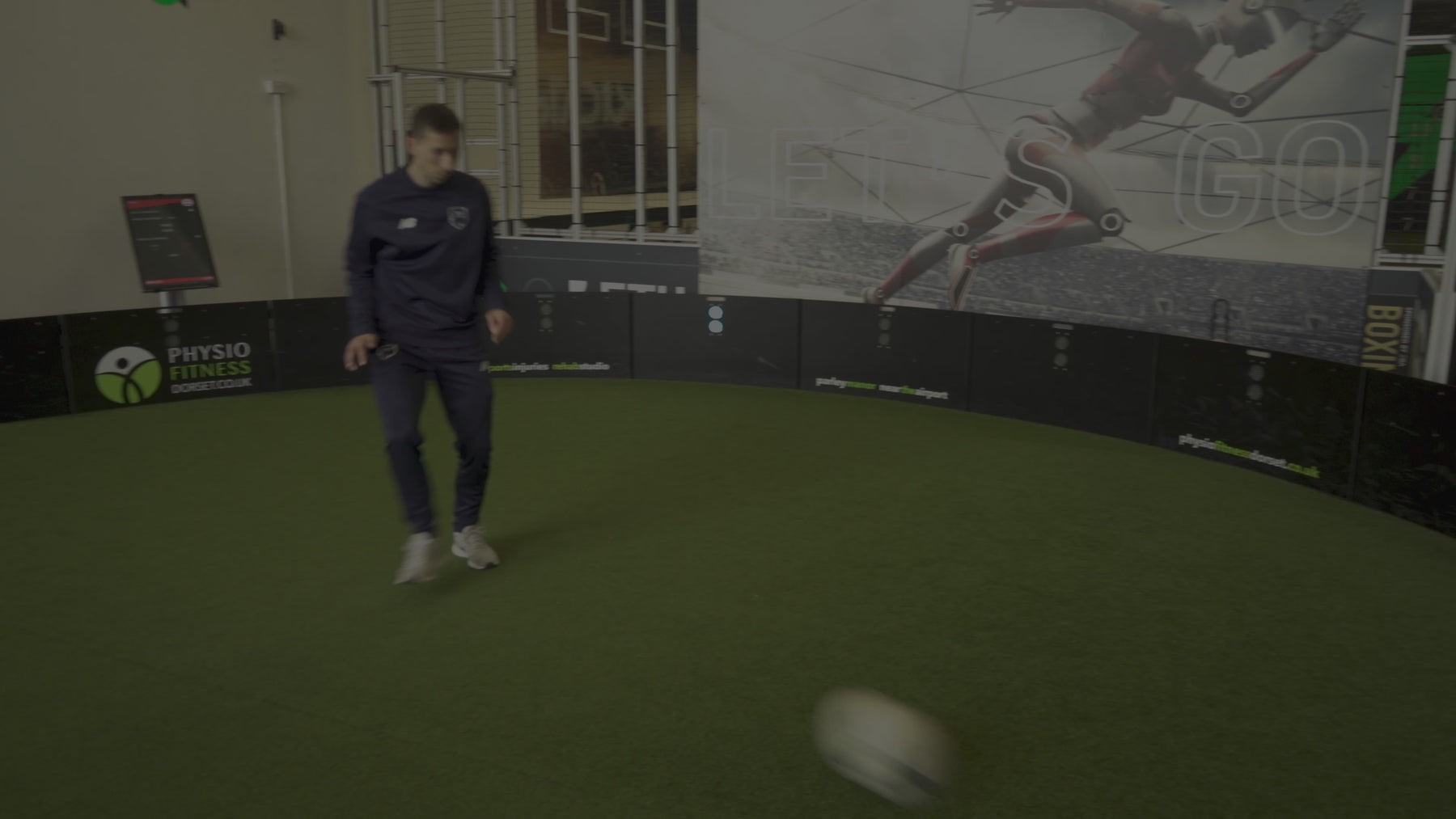 video of man demonstrating how decision maker game mode works on acura elite esa products inside training facility with astro turf