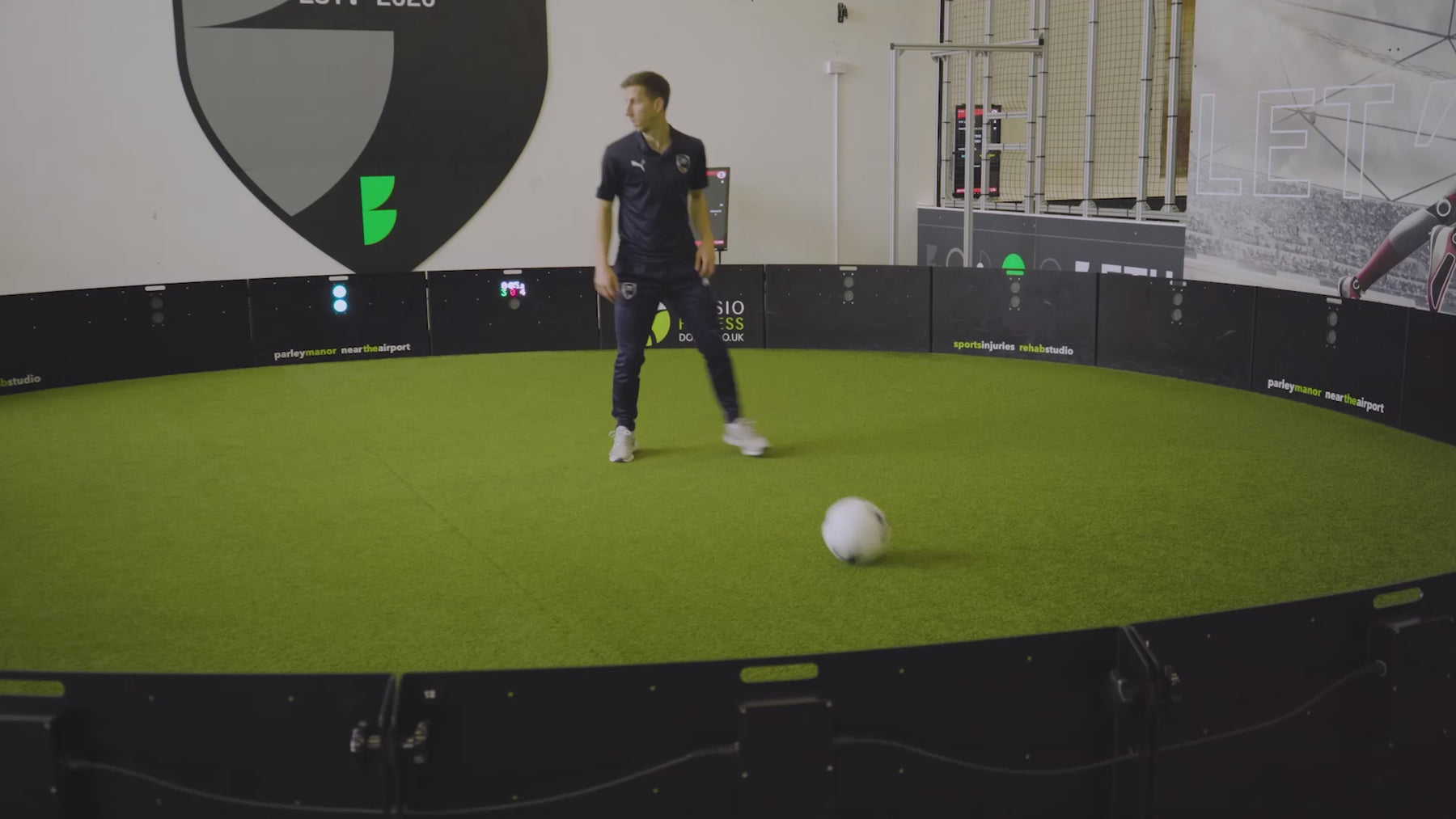 video of man demonstrating how pass finder game mode works on acura elite esa products inside training facility with astro turf