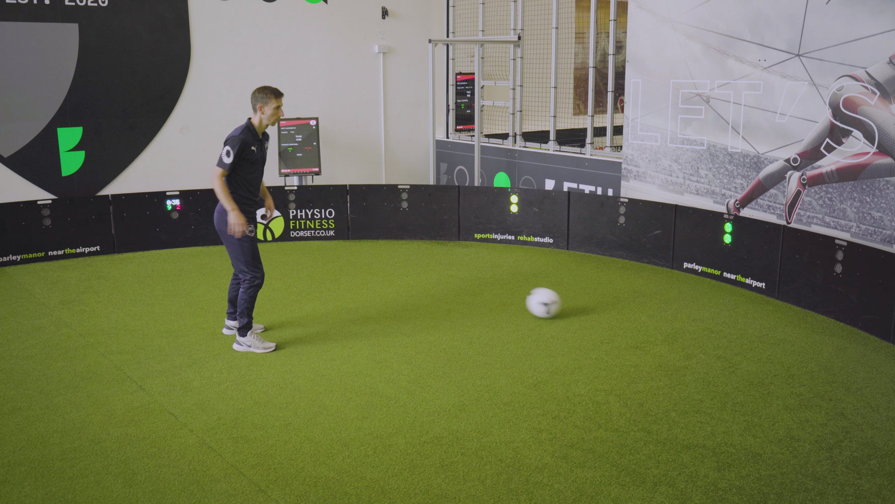 video of man demonstrating how the vision game mode works on acura elite esa products inside training facility with astro turf