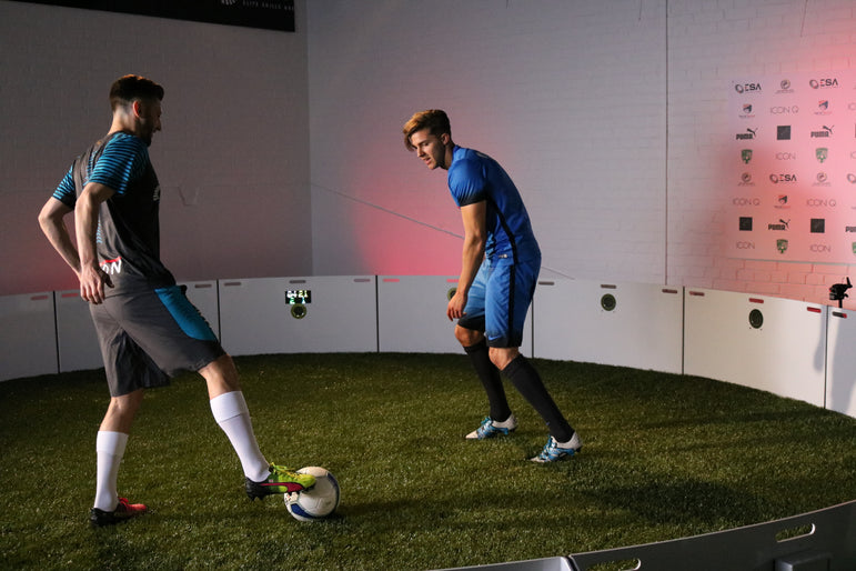two men in football kits using acura icon arena 6m 16-panel branded white inside